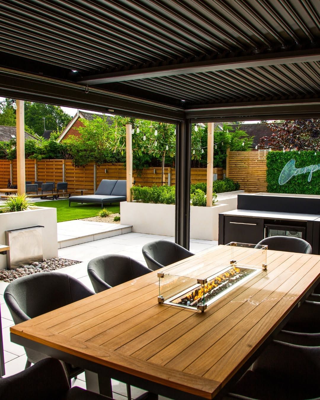 Garden seating area surrounded by lush, layered planting